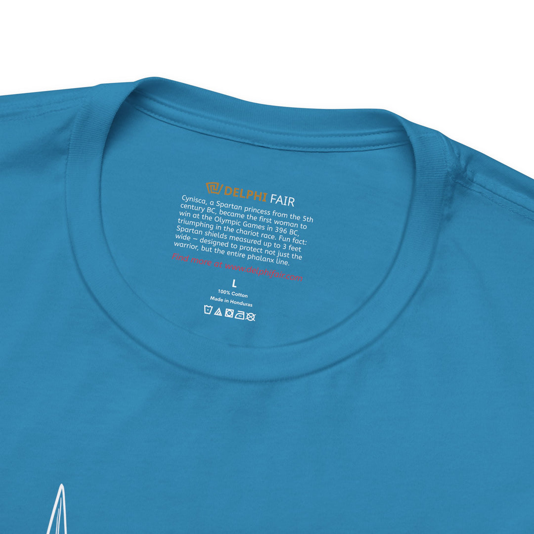 Close-up of a aqua t-shirt neck label with the text about Cynisca, ancient Sparta’s first female Olympic champion, and a fun fact about Spartan shields being up to 3 feet wide to protect the entire phalanx formation.