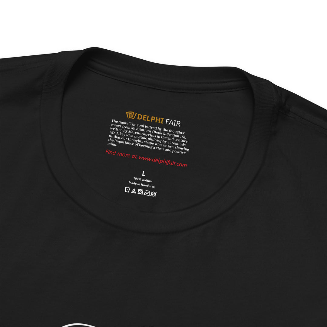 Close-up of black t-shirt neck label with the phrase 'The soul is dyed by the thoughts' and a brief note about its origin from Marcus Aurelius.
