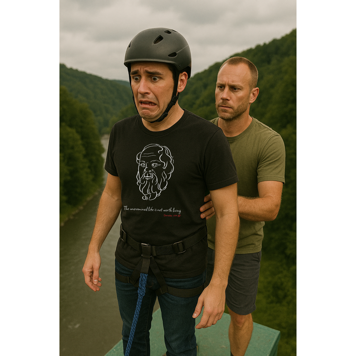 "Scared man on a platform preparing for a bungee jump, wearing a black t-shirt with a white graphic of Socrates's head, the quote 'The unexamined life is not worth living,' and red text 'Socrates, 399 BC' below.