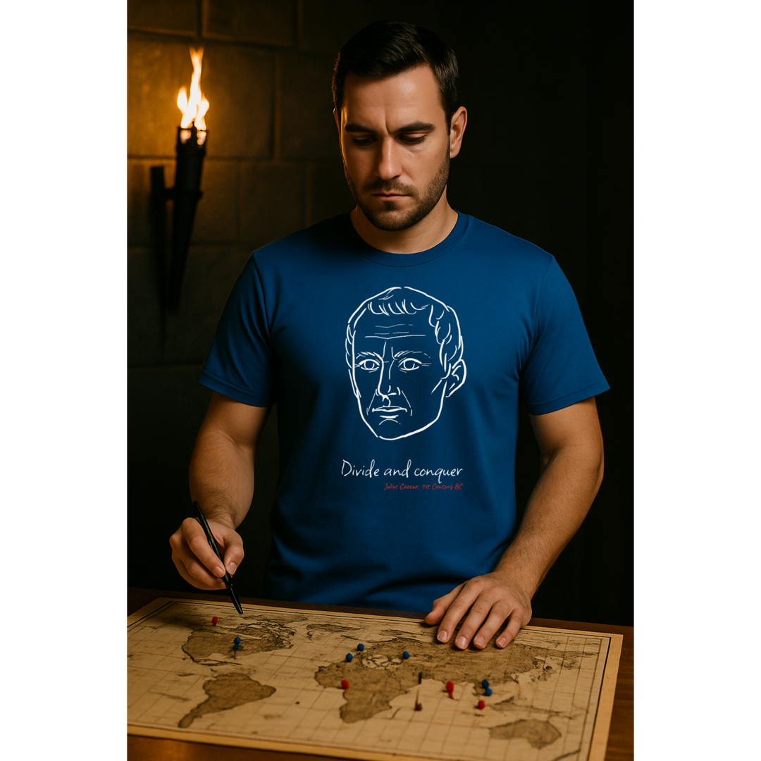 Man looking at a map wearing a blue t-shirt with a white graphic of Julius Caesar's head, the quote 'Divide and conquer,' and the red text 'Julius Caesar, 1st Century BC' below