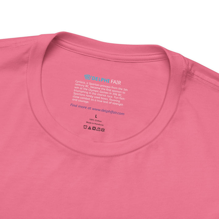 Close-up of a dark-pink t-shirt neck label with the text about Cynisca, the first woman to win at the Olympic Games, and a fun fact about Spartan warriors preferring close combat over bows.