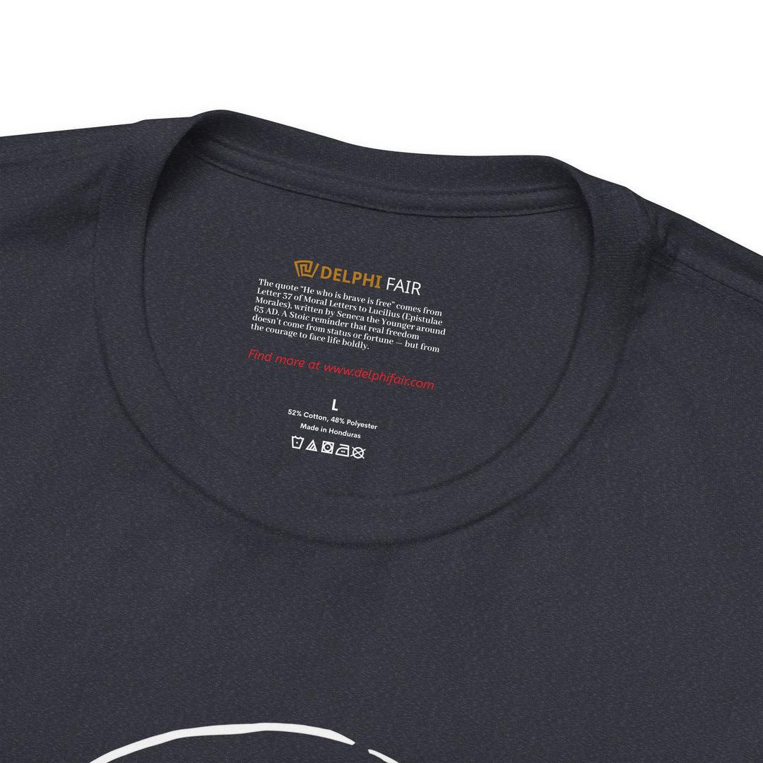 Close-up of a heather navy t-shirt neck label featuring the phrase 'He who is brave is free,' with a note about its meaning and origin from Seneca's letters written in 63 AD.
