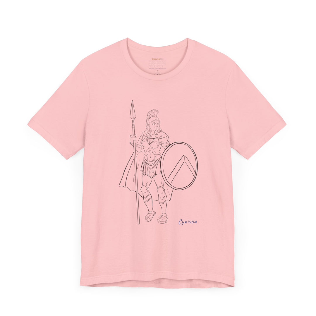 Pink t-shirt with a black line graphic of Cynisca standing in full Spartan armor, holding a spear and a round shield with a lambda symbol, with the blue text 'Cynisca' below the design.