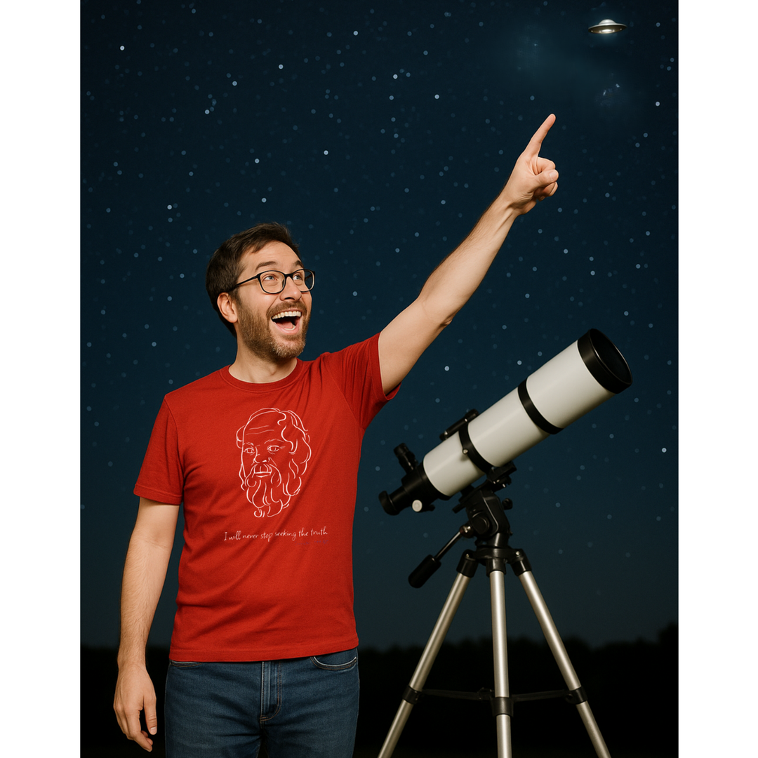 Excited man pointing his finger at small flying object in the night sky. He is wearing a red t-shirt with a white graphic of Socrates's head, the quote 'I will never stop seeking the truth' and the blue text 'Socrates 399 BC' below.