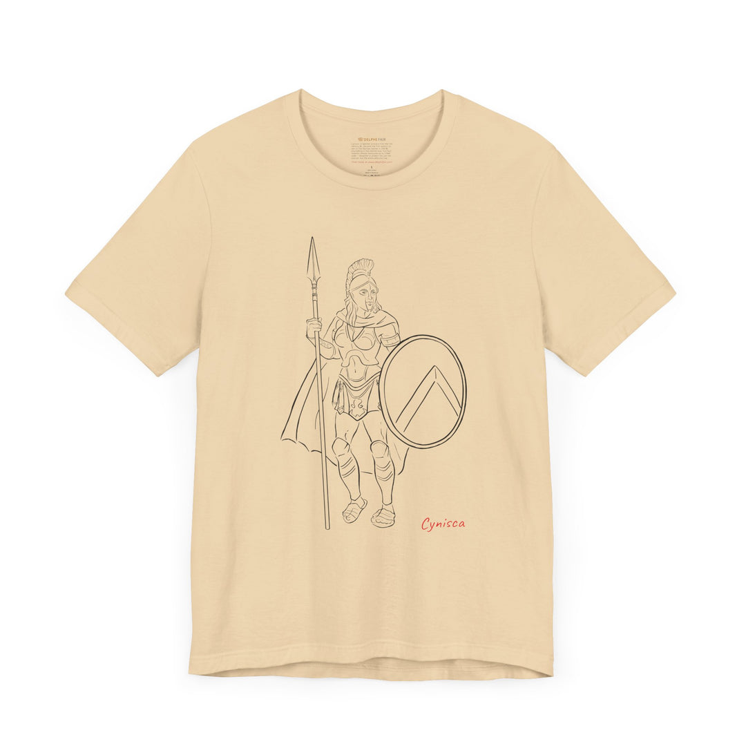 Soft-cream t-shirt with a black line graphic of Cynisca standing in full Spartan armor, holding a spear and a round shield with a lambda symbol, with the red text 'Cynisca' below the design.