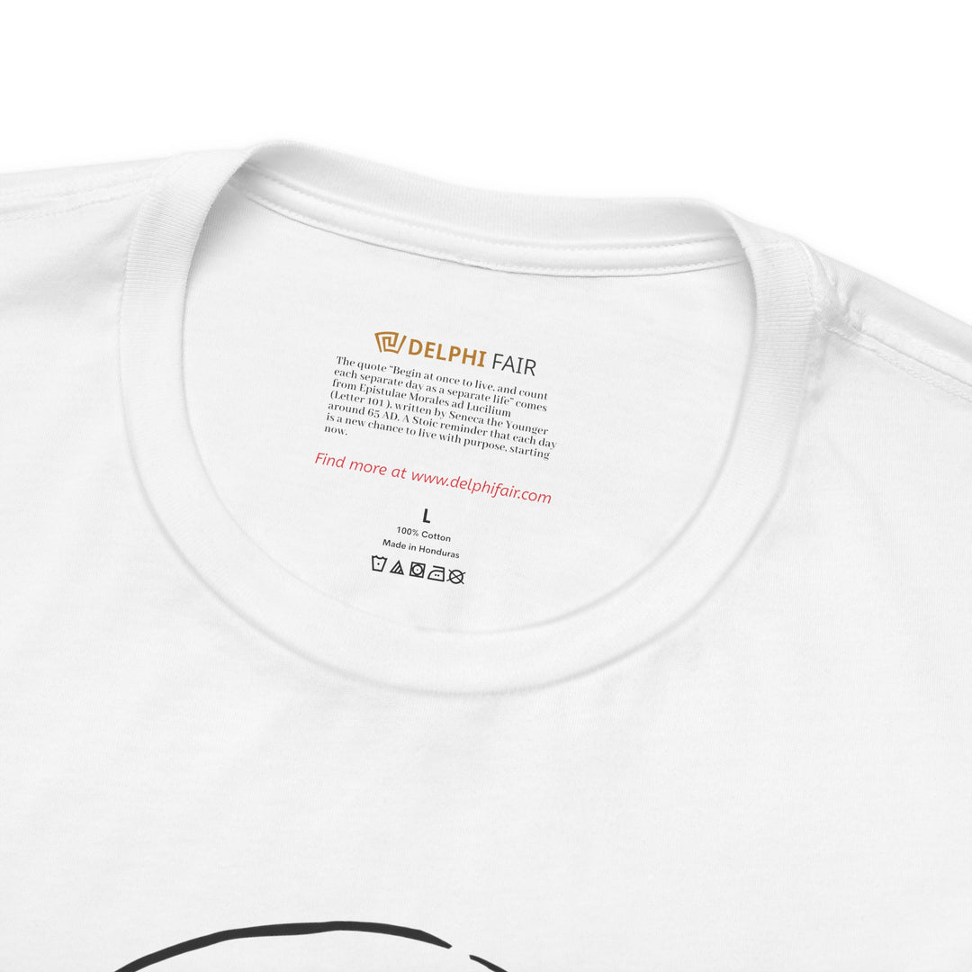 Close-up of a white t-shirt neck label featuring the phrase 'Begin at once to live, and count each separate day as a separate life' with a note about its meaning and origin from Seneca's letters written around 65 AD."